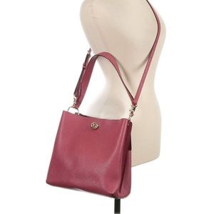 Adjustable shoulder strap, 9.5" drop. Dual compartments; turn-lock closures